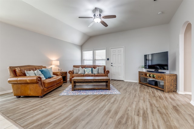 living room featuring ceiling fan, light hardwood / wood-style floors, and vaulted ceiling