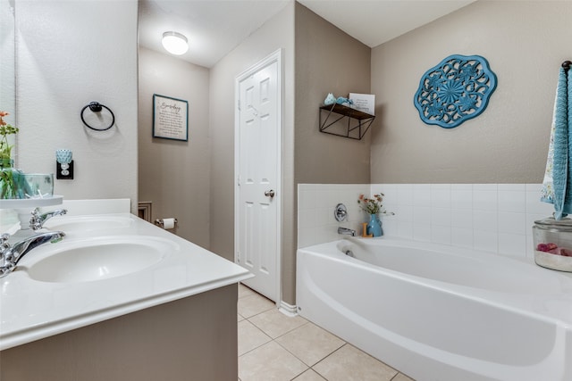 bathroom with tile patterned flooring, vanity, and a tub to relax in