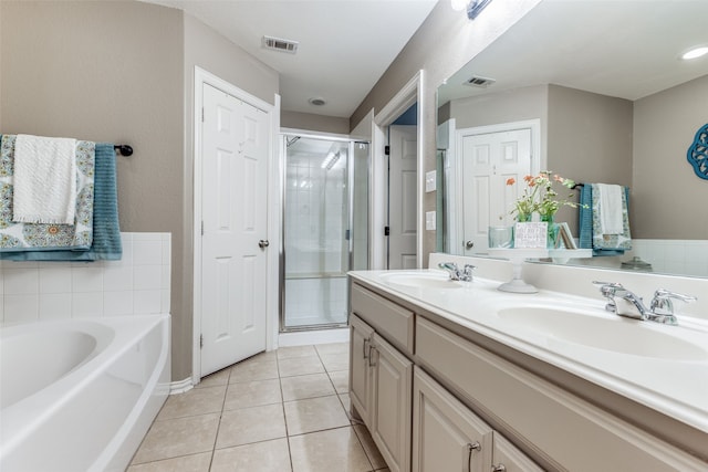 bathroom with tile patterned flooring, vanity, and shower with separate bathtub