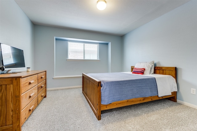 bedroom featuring light colored carpet