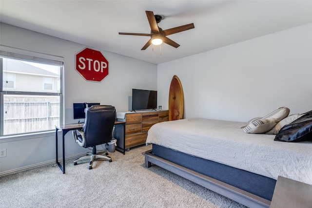 carpeted bedroom with ceiling fan and multiple windows