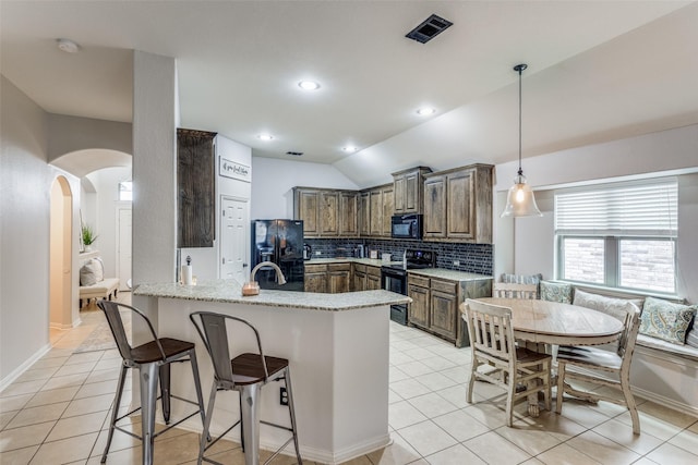 kitchen with kitchen peninsula, lofted ceiling, decorative backsplash, light tile patterned flooring, and black appliances