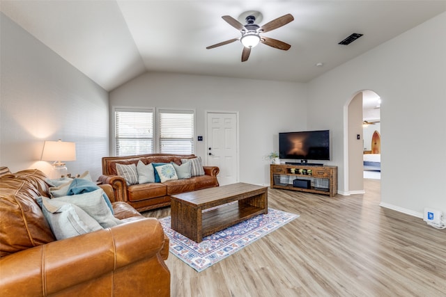 living room with ceiling fan, light wood-type flooring, and lofted ceiling