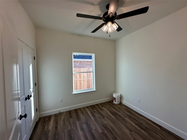 spare room featuring ceiling fan and dark wood-type flooring