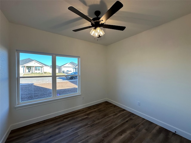 empty room with ceiling fan and dark wood-type flooring