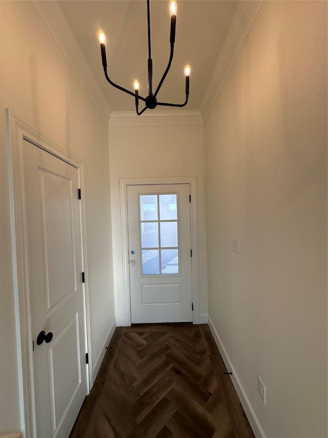 doorway to outside featuring dark parquet flooring, an inviting chandelier, and ornamental molding