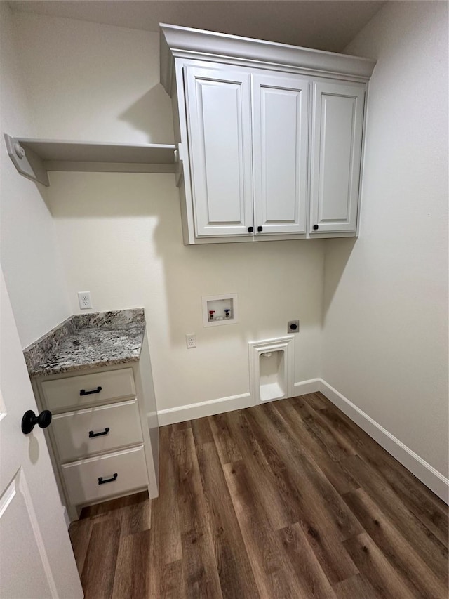 clothes washing area with hookup for an electric dryer, hookup for a washing machine, dark wood-type flooring, and cabinets