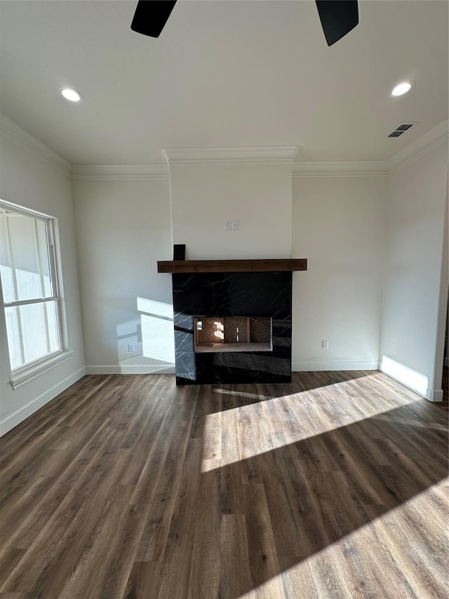 unfurnished living room with crown molding and dark hardwood / wood-style flooring