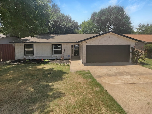 single story home featuring a garage and a front lawn