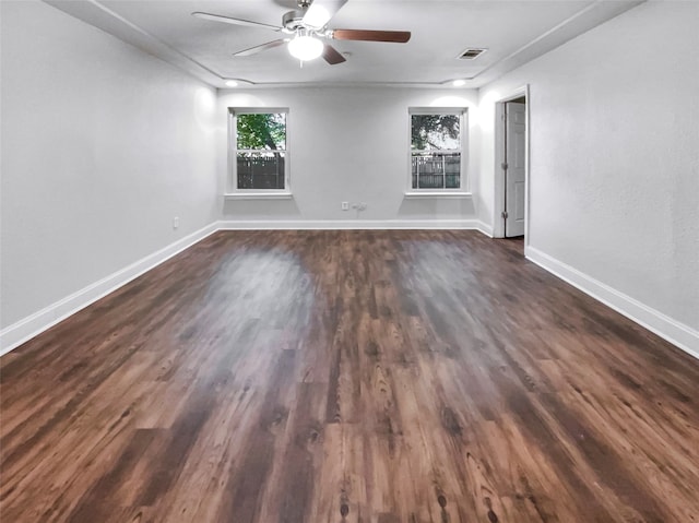 empty room featuring dark wood-type flooring and ceiling fan