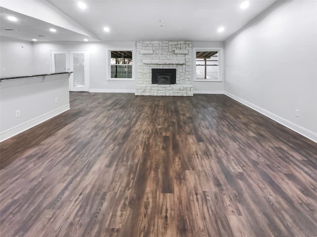 unfurnished living room featuring dark hardwood / wood-style floors and vaulted ceiling