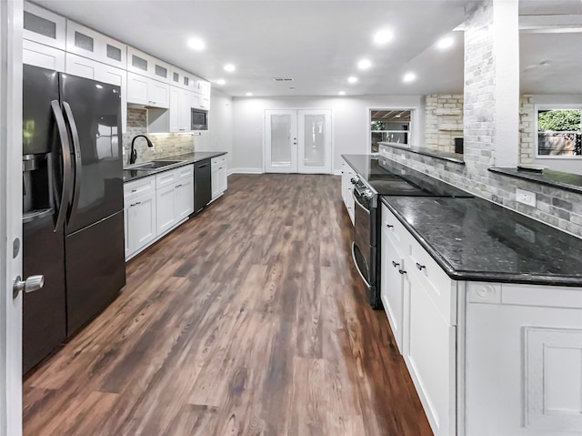 kitchen featuring black appliances, backsplash, dark hardwood / wood-style flooring, and white cabinets