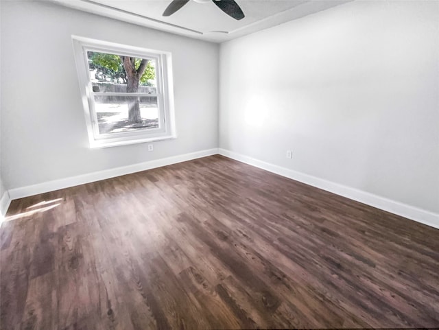 spare room featuring ceiling fan and dark wood-type flooring