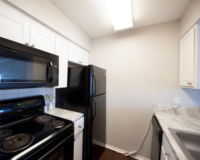 kitchen featuring range, sink, backsplash, a textured ceiling, and white cabinetry