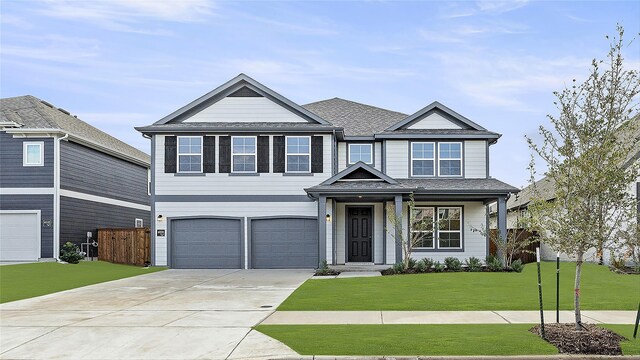 view of front facade featuring a front yard and a garage