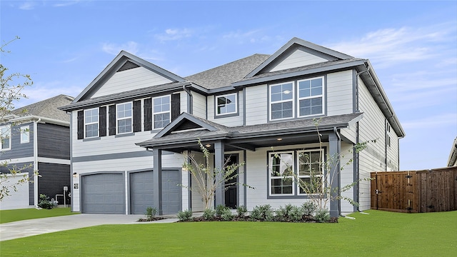 view of front of home with a garage and a front lawn