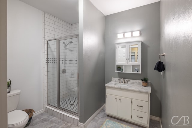 bathroom with a shower with door, vanity, and toilet