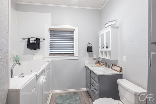 bathroom featuring toilet, wood-type flooring, a tub, ornamental molding, and vanity