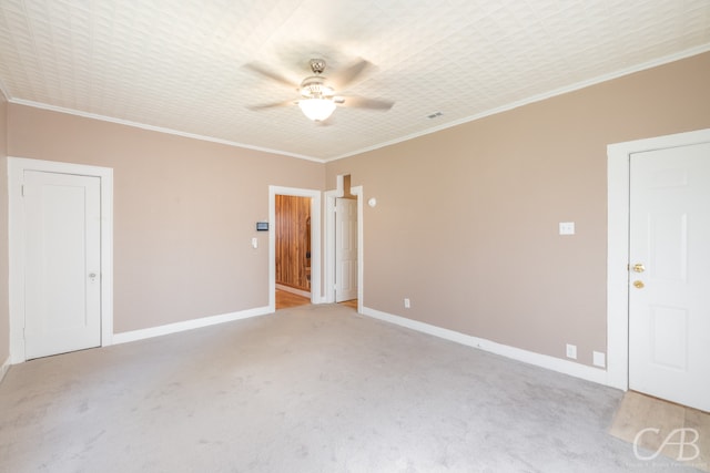 unfurnished room featuring ceiling fan, light colored carpet, and ornamental molding