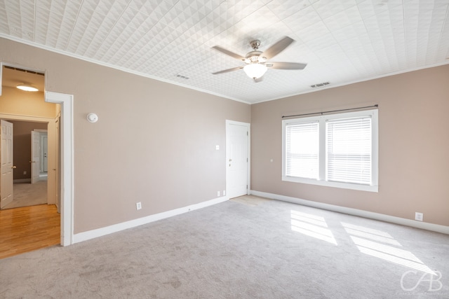 carpeted empty room featuring ornamental molding and ceiling fan