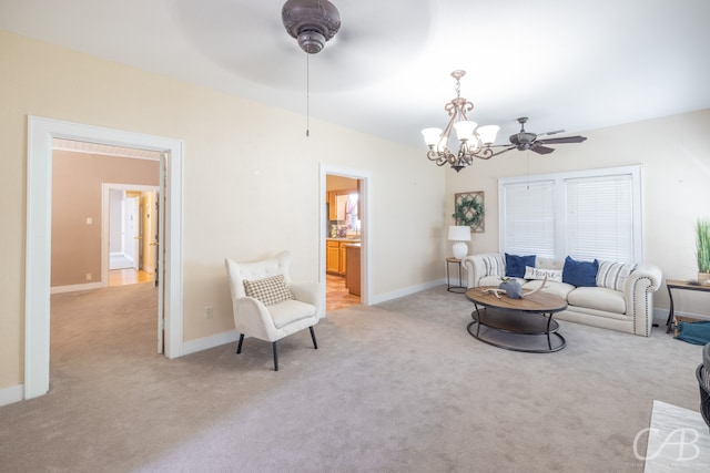 living room with ceiling fan with notable chandelier and light carpet