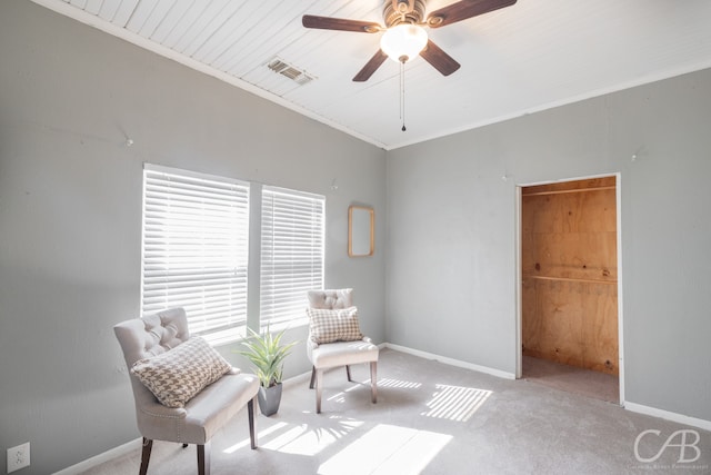 living area with light carpet, ornamental molding, wooden ceiling, and ceiling fan