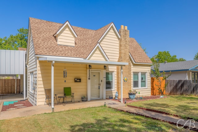 view of front facade featuring a front lawn and a patio