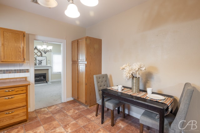 carpeted dining space featuring a chandelier