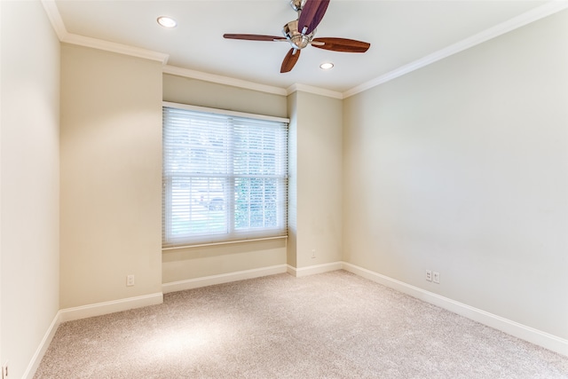 carpeted spare room featuring ornamental molding and ceiling fan