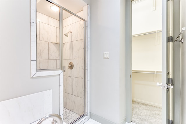 bathroom featuring a shower with door