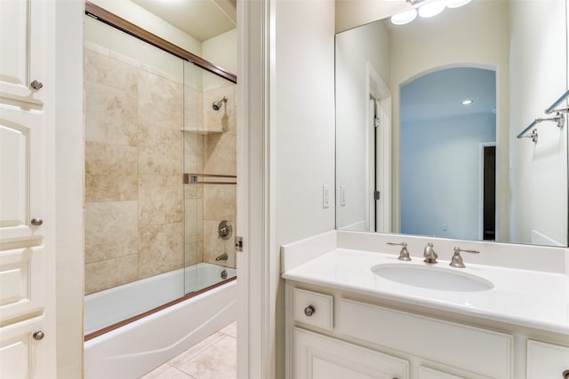 bathroom with tile patterned flooring, bath / shower combo with glass door, and vanity