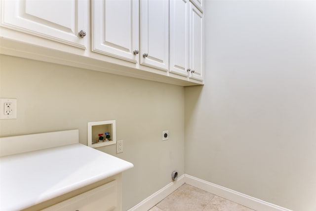 laundry room featuring cabinets, light tile patterned floors, hookup for an electric dryer, and washer hookup