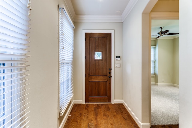 doorway to outside with hardwood / wood-style flooring, a healthy amount of sunlight, crown molding, and ceiling fan