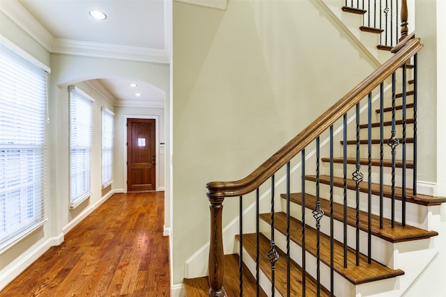 foyer featuring ornamental molding and hardwood / wood-style floors