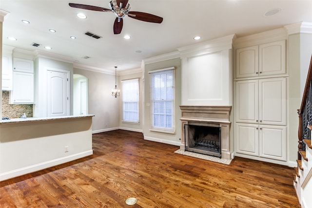 unfurnished living room featuring ornamental molding, hardwood / wood-style flooring, and ceiling fan