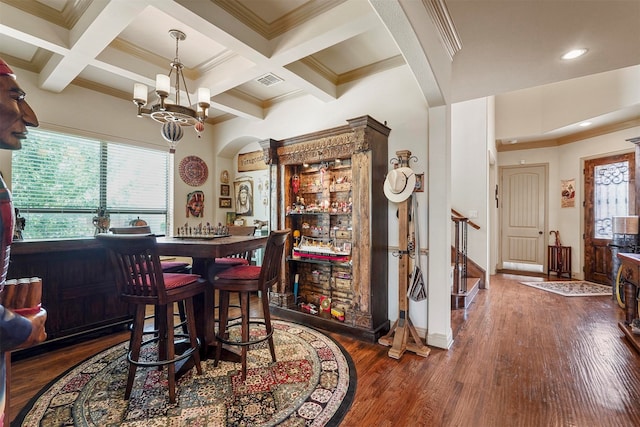 dining area with beam ceiling, a notable chandelier, hardwood / wood-style floors, and coffered ceiling