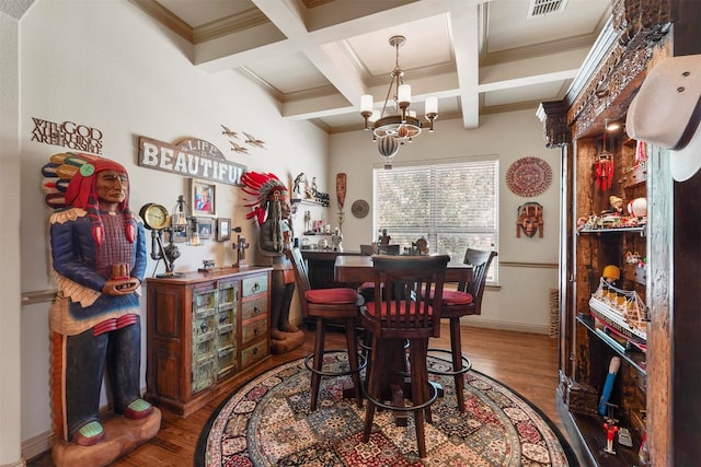 dining room featuring hardwood / wood-style floors, a notable chandelier, beam ceiling, and coffered ceiling