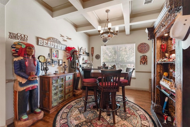 dining room featuring coffered ceiling, hardwood / wood-style floors, an inviting chandelier, and beam ceiling