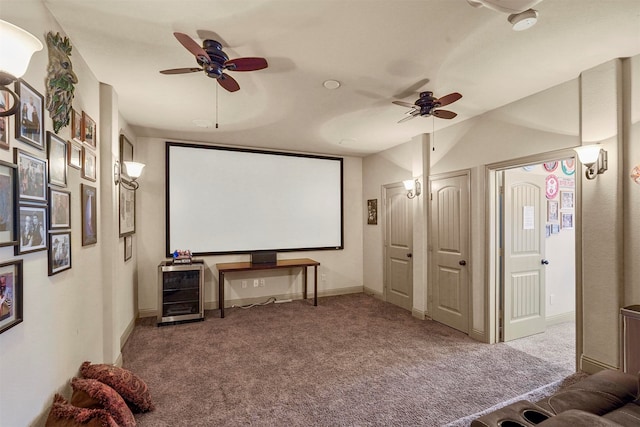 carpeted home theater with ceiling fan and lofted ceiling