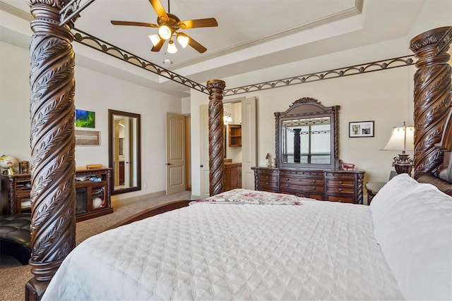 bedroom with a tray ceiling, ornamental molding, carpet flooring, and ceiling fan