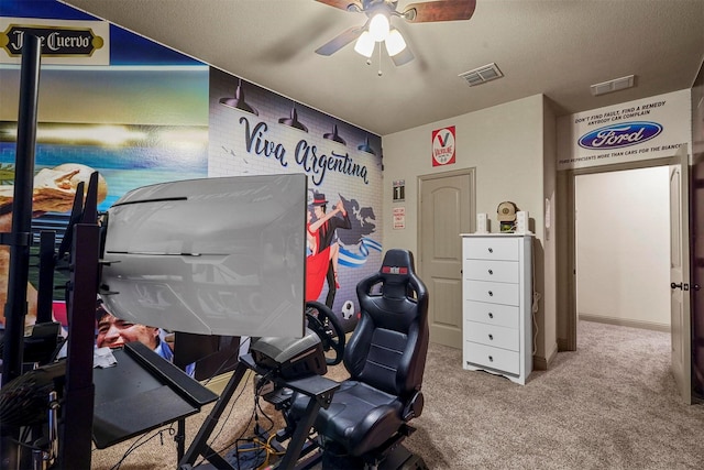 miscellaneous room with carpet, ceiling fan, and a textured ceiling