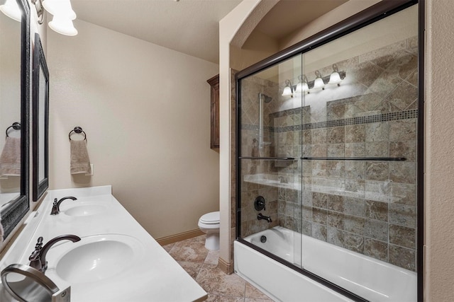 full bathroom with vanity, combined bath / shower with glass door, toilet, and tile patterned flooring