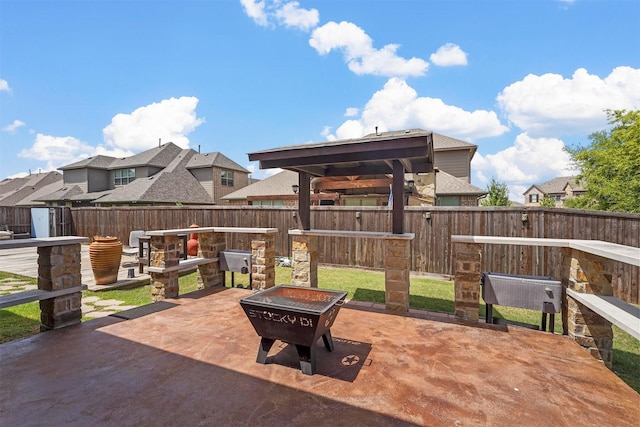 view of patio with an outdoor fire pit and a gazebo