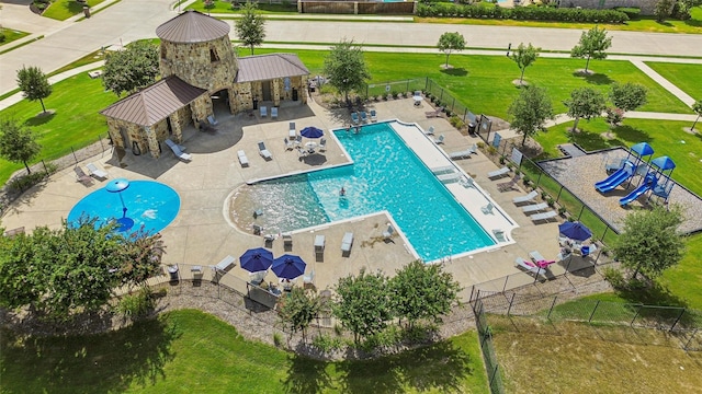 view of pool with a lawn and a patio area