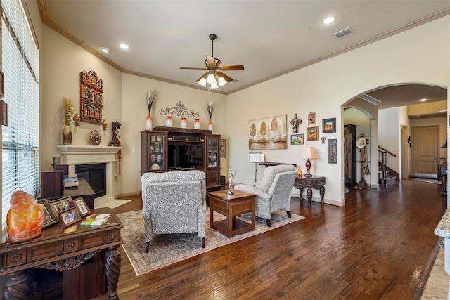 living room with ornamental molding, hardwood / wood-style floors, and ceiling fan