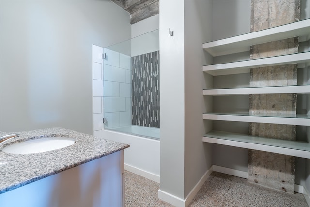 bathroom with tiled shower / bath combo and vanity