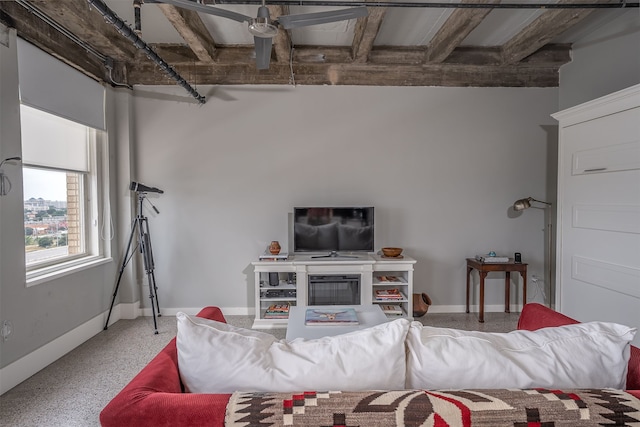 carpeted living room with beamed ceiling