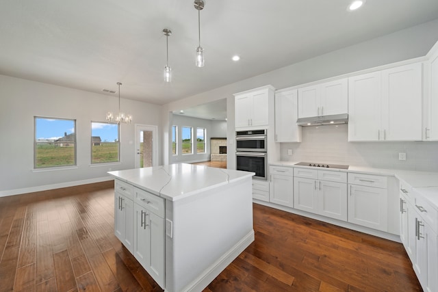 kitchen with a center island, white cabinetry, and dark hardwood / wood-style flooring