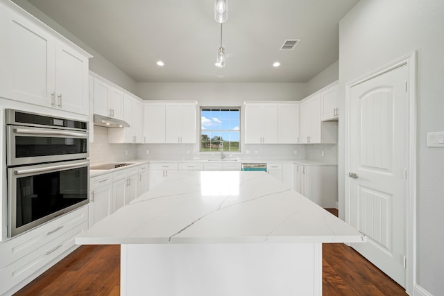 kitchen with a kitchen island, decorative light fixtures, and dark hardwood / wood-style flooring