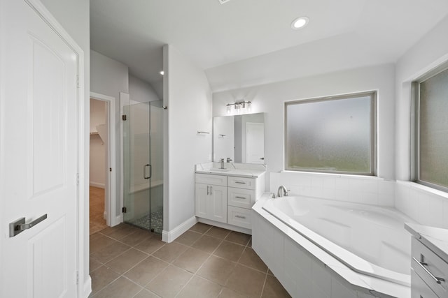 bathroom featuring vanity, shower with separate bathtub, and tile patterned flooring